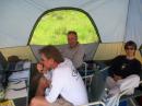 Phil, NØVOD, (left) makes a Field Day contact with his dad, Jerry, W6IWR, while his wife Debbie (right) looks on. Ash, WWØAL, is the GOTA control operator.